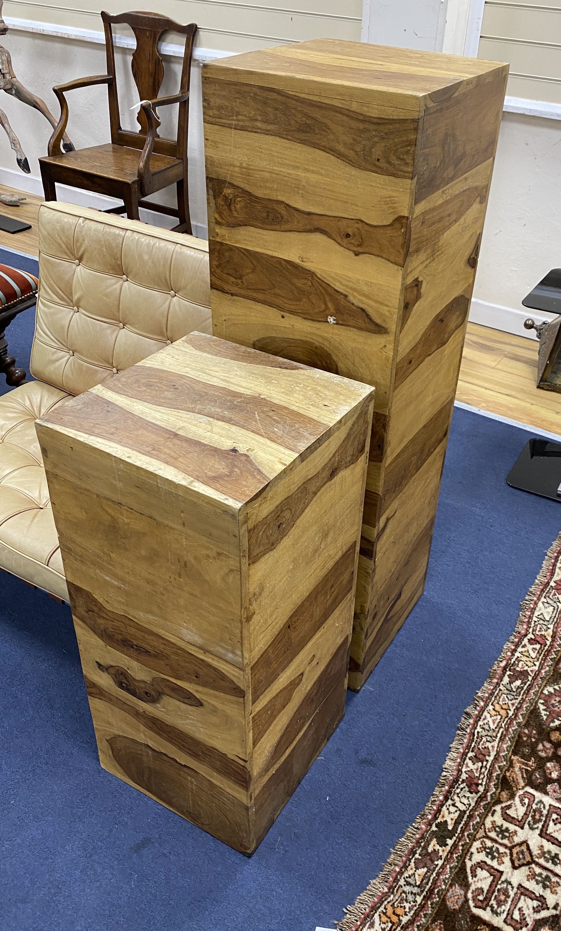 Two olive wood wooden plinths, larger height 122cm